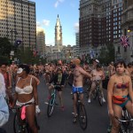 9-9 bike riders with city&nbsp;hall